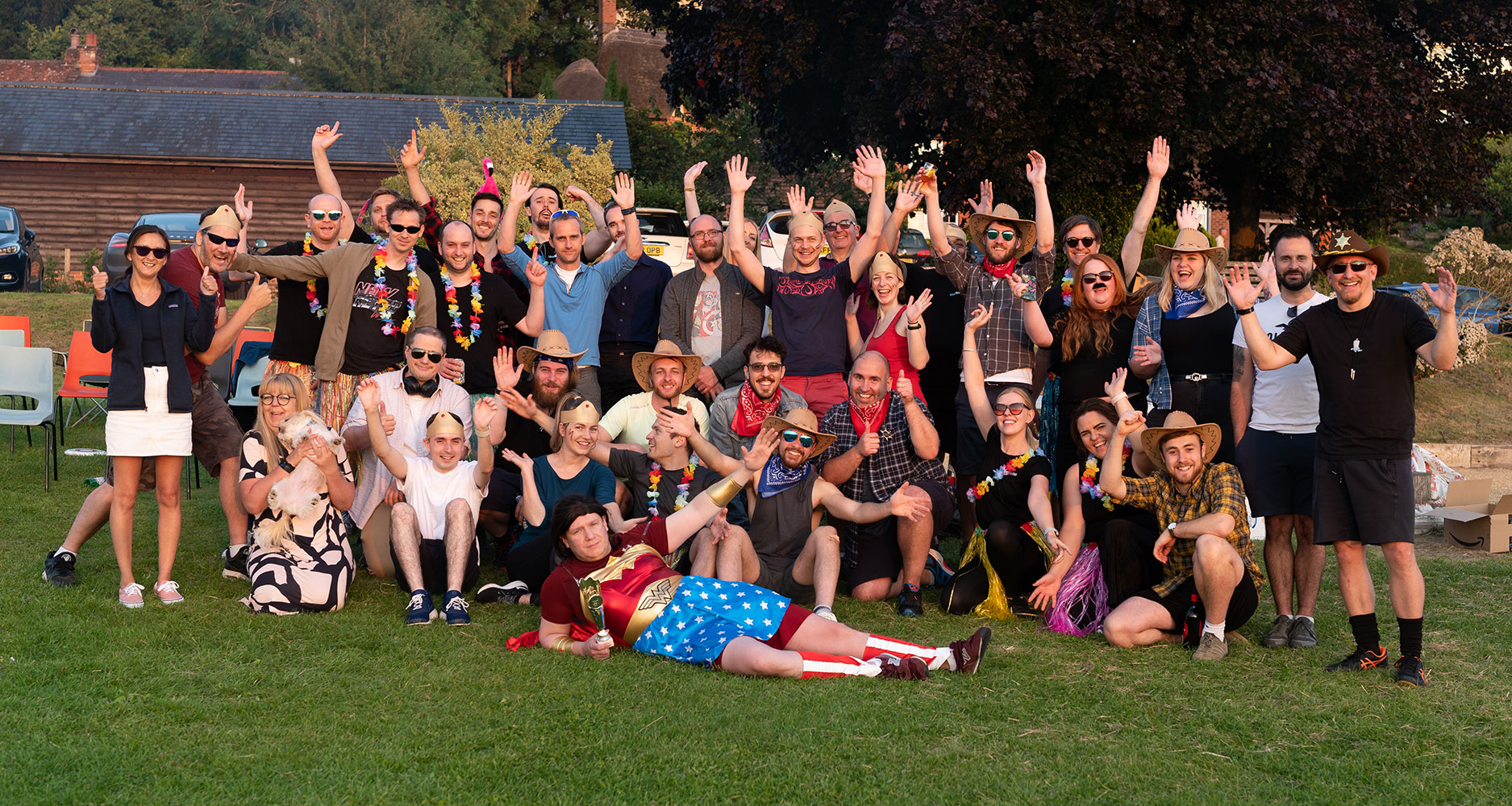 Group photo of the cobolt team with their arms in the air smiling at a social event