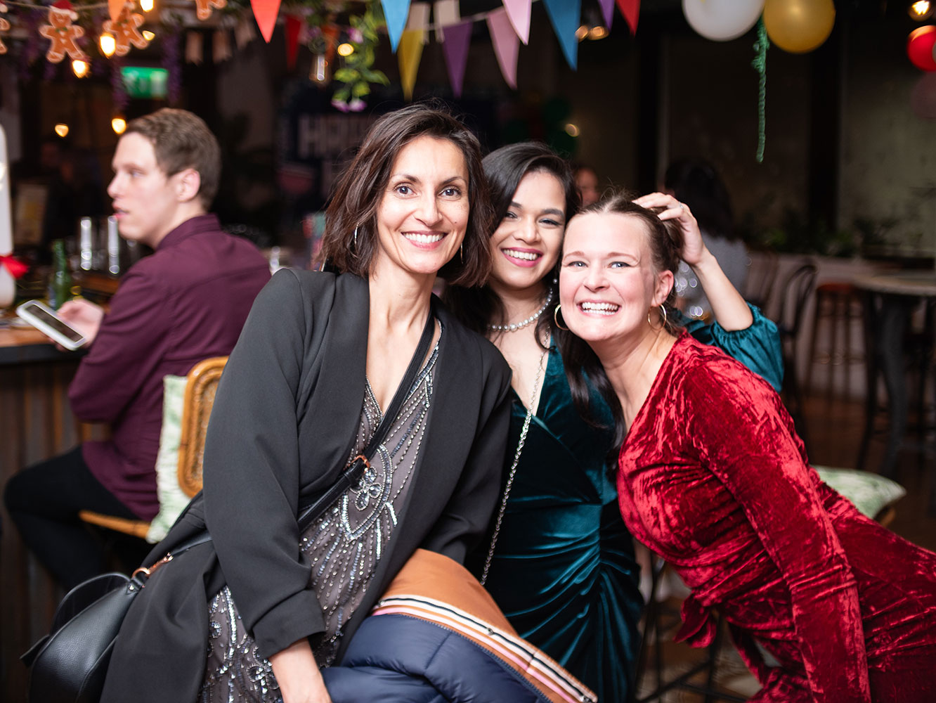 Group photo of 3 women posing together and smiling at cobolt's Christmas event