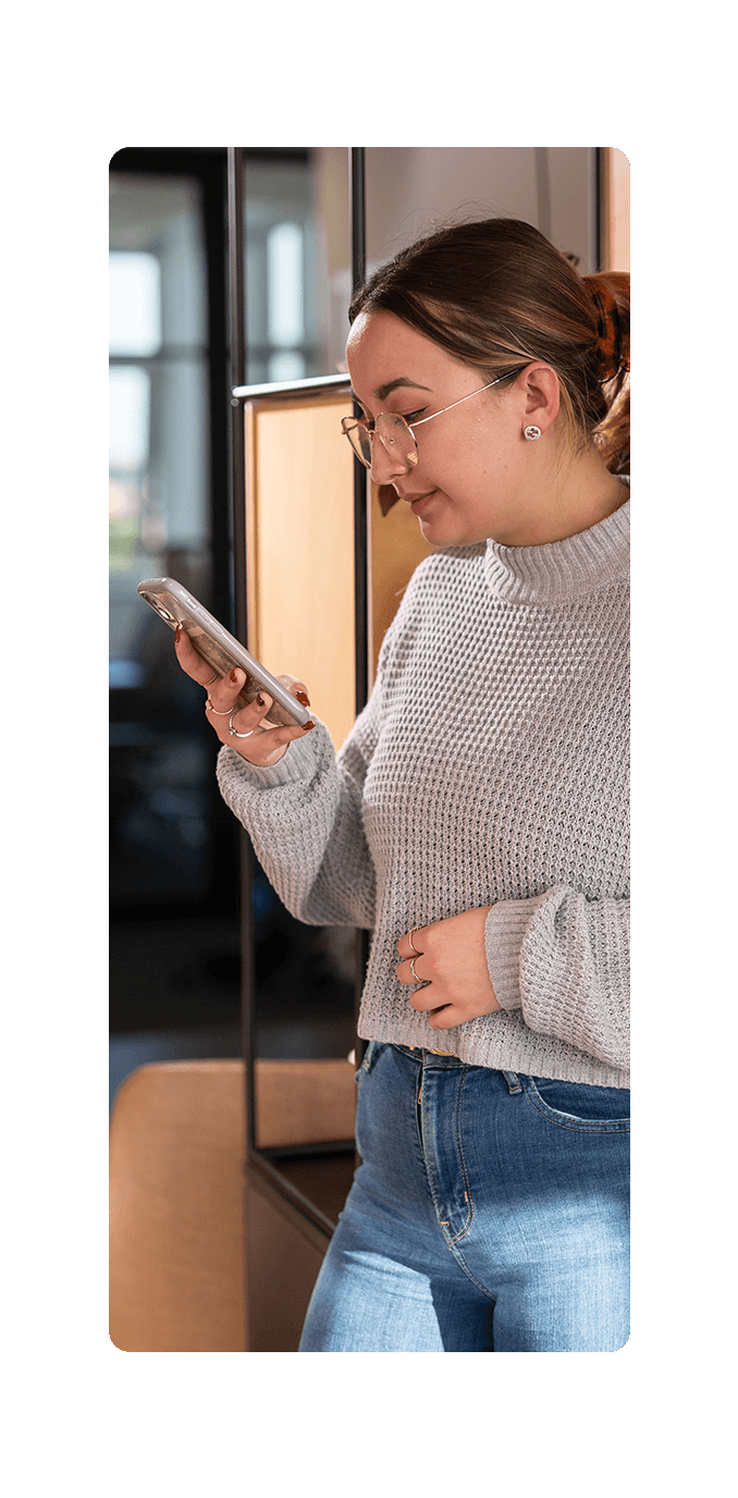 woman checking phone in office 