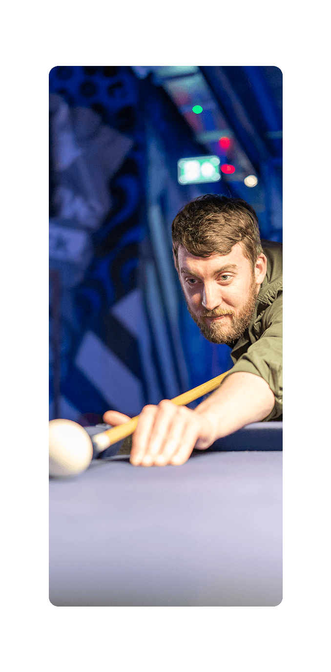 man lining up a shot in pool